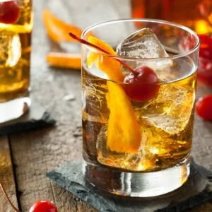 Homemade Old Fashioned Cocktail with Cherries and Orange Peel